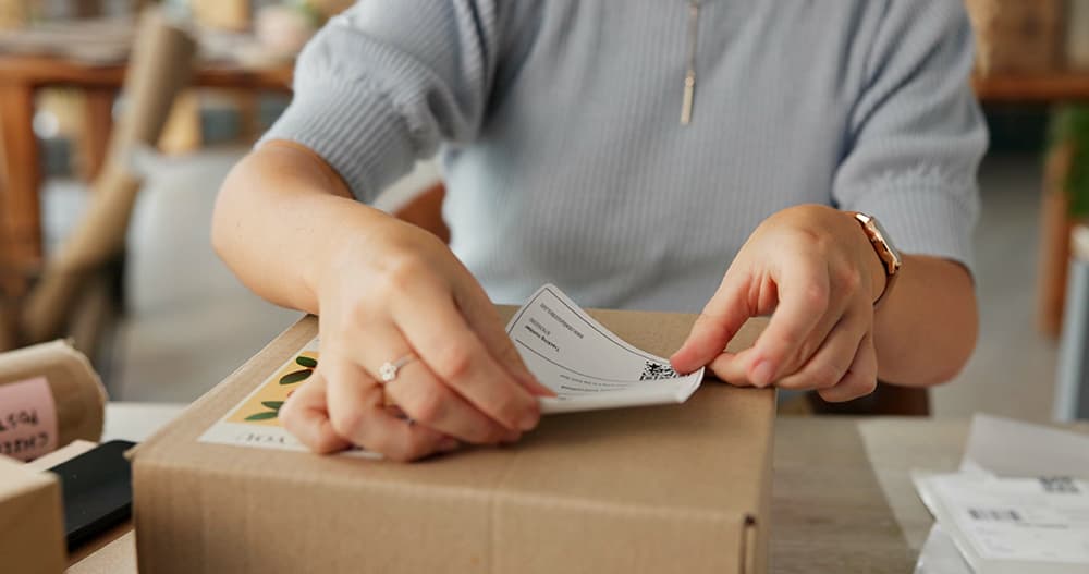 Man put label on international shipment box